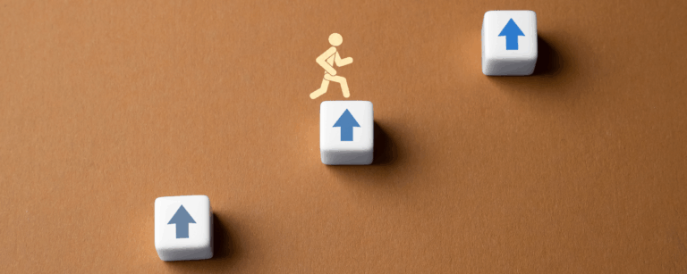 Three levels of blocks with person jumping up them.
