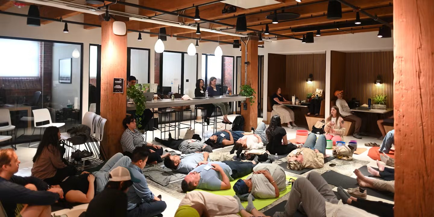 Attendees lying down during a sound bowl healing session at The Experiment during Boston Tech Week